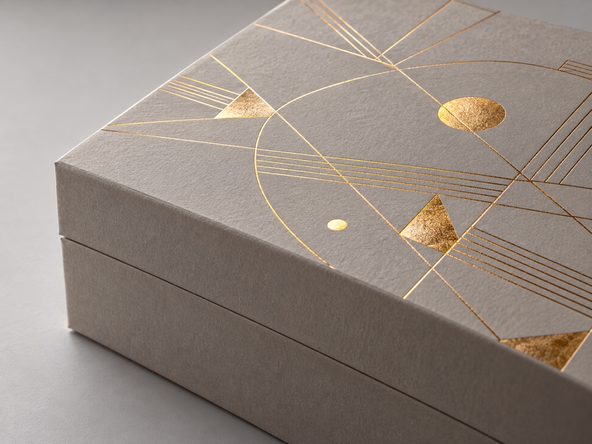 Concept detail of reflective gold foil stamped on a paper gift box